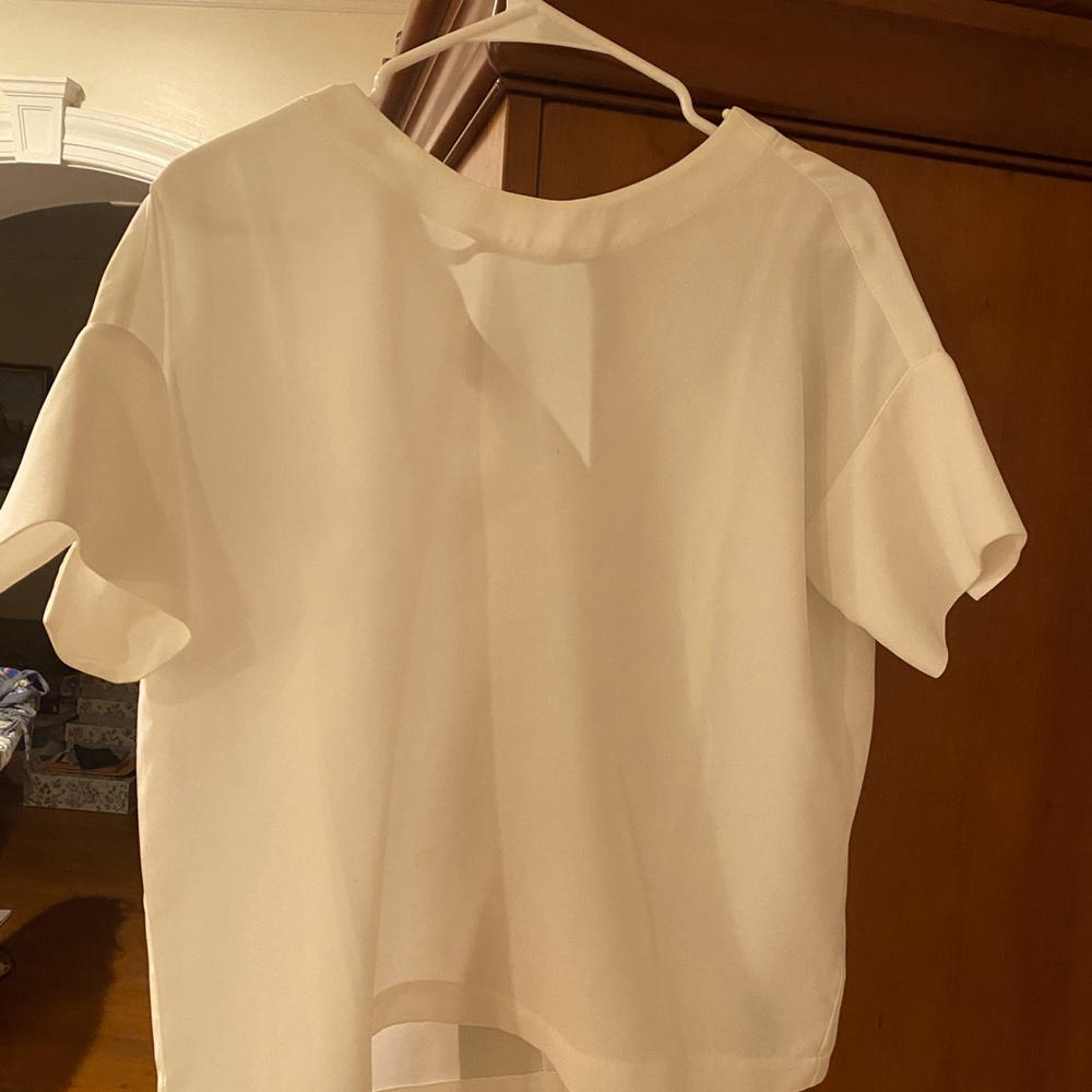 White short sleeve  blouse with cute bow tie back and flattering short sleeve.